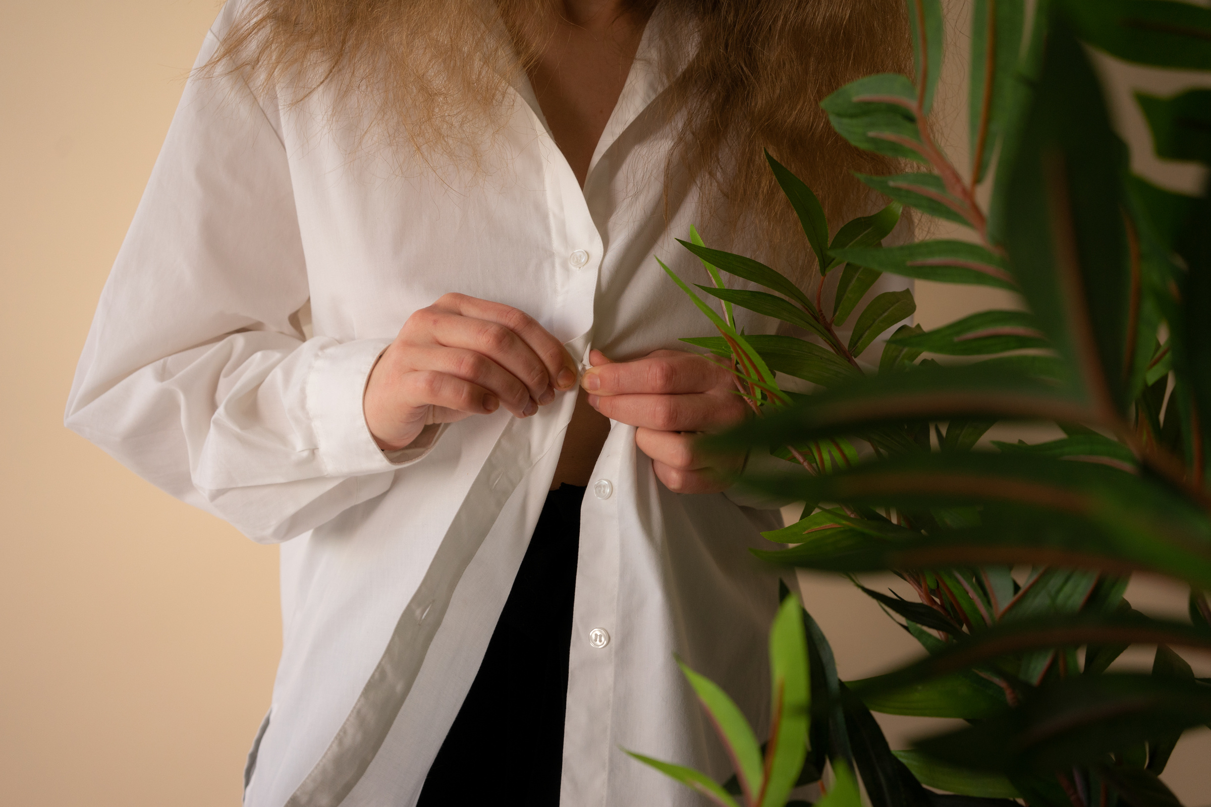 Woman in White Button Up Long Sleeve Shirt Near Green Plant